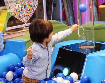 A child is playing at Cloud Twelve's play zone
